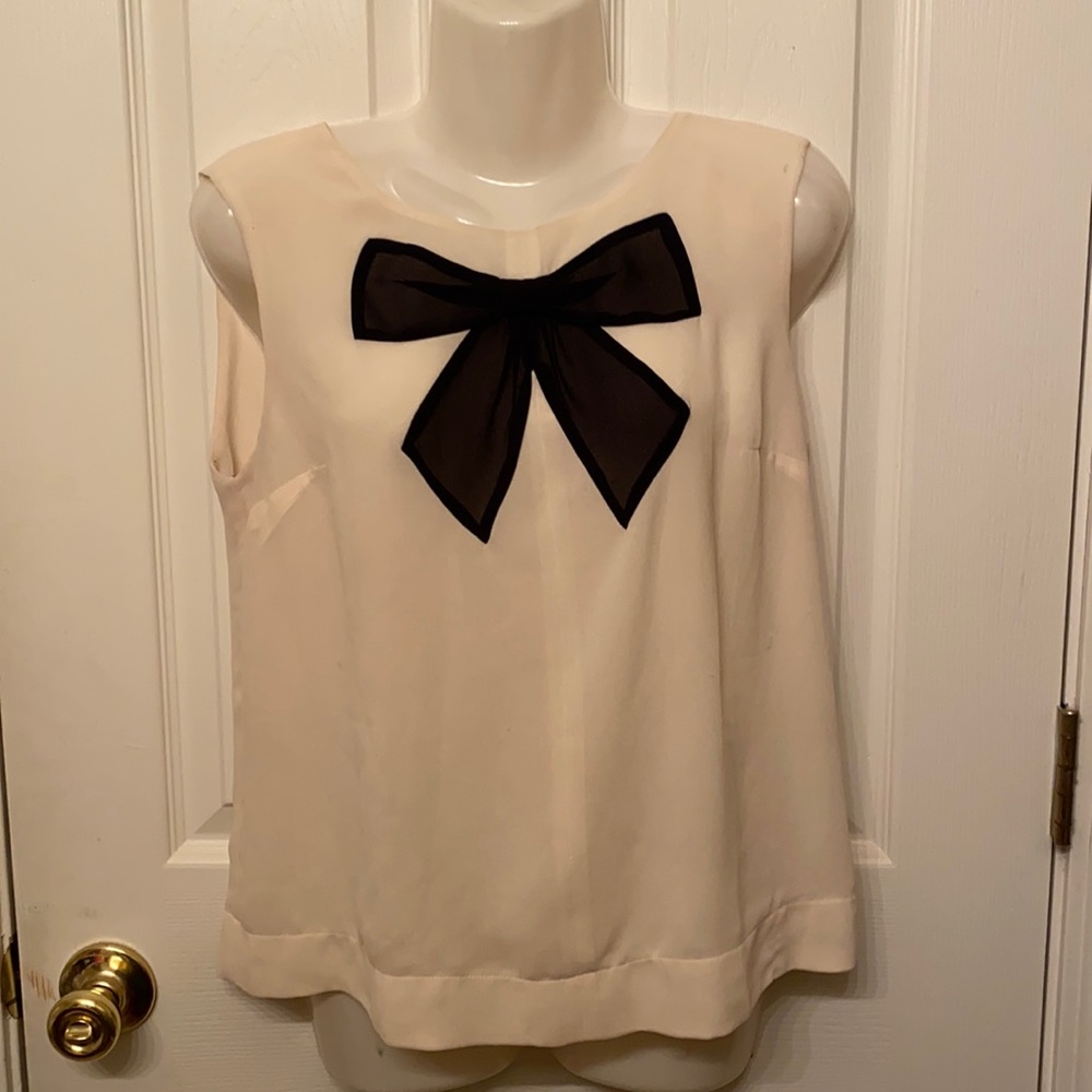 Float, Cream-Colored Top with Black Bow detail.